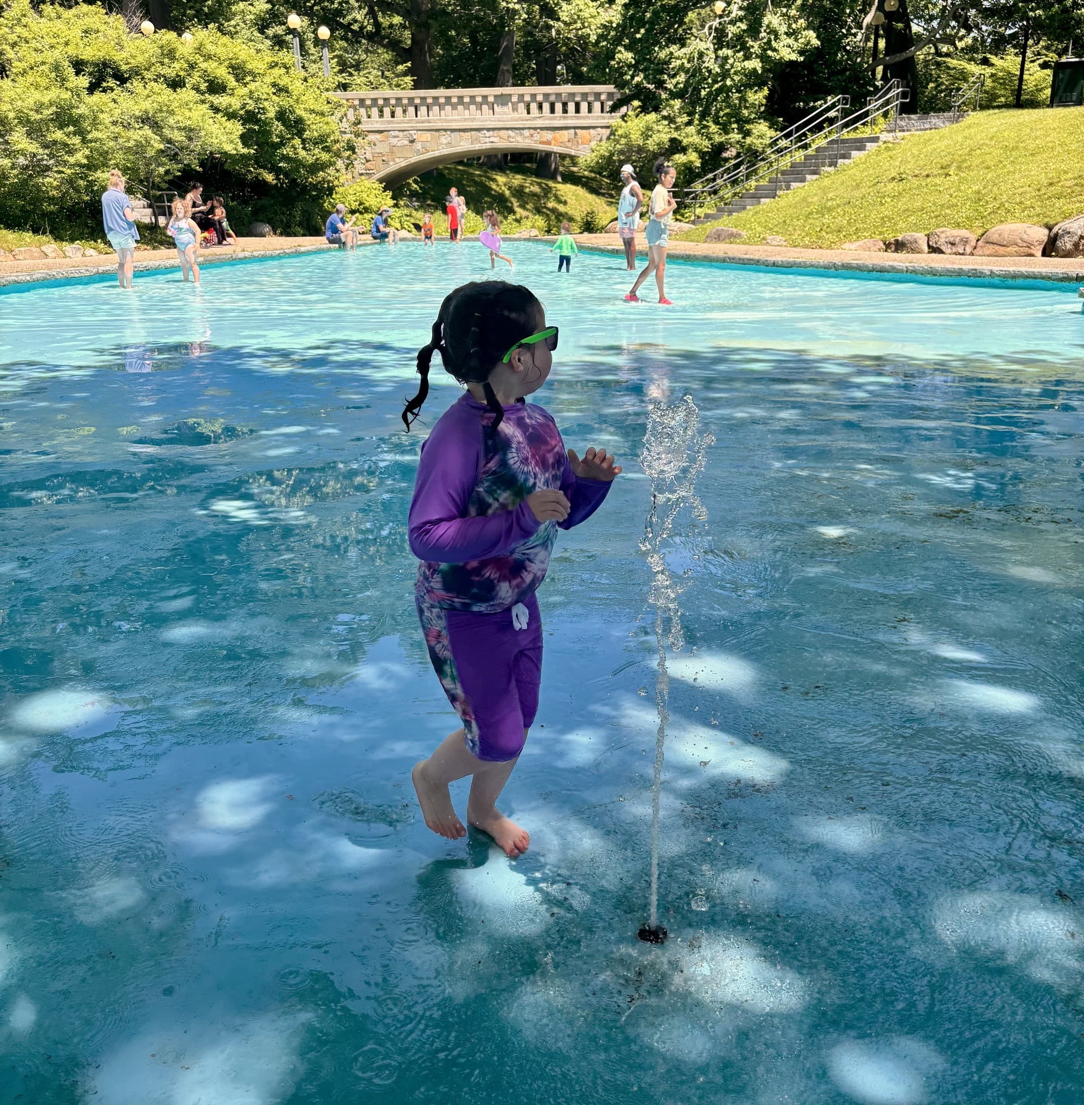 Family playing together at a splash pad