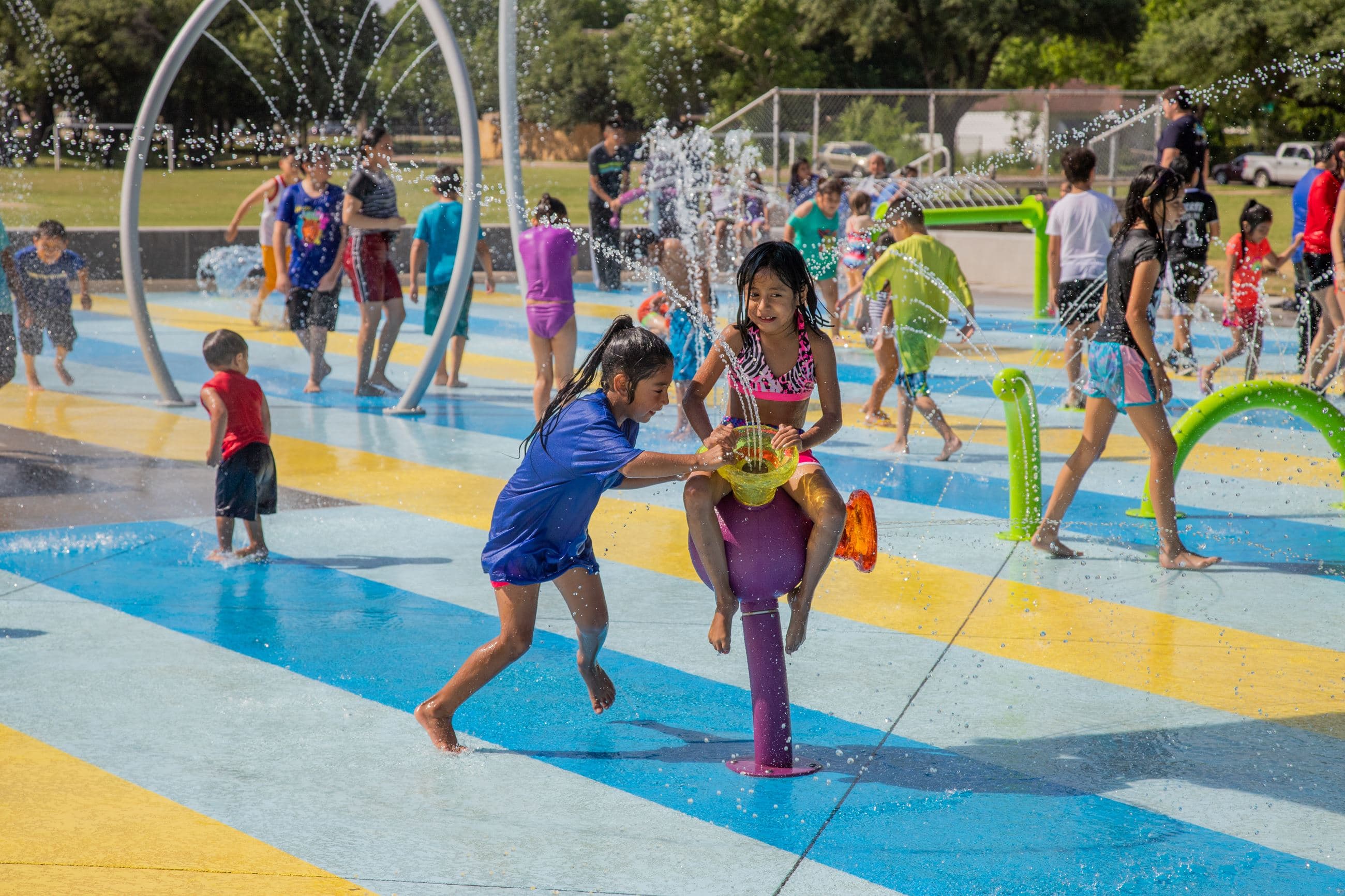 Kids playing at a Dallas splash pad on a hot summer day